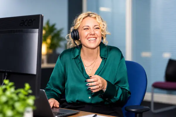 A member of our team speaking on a headset in the office