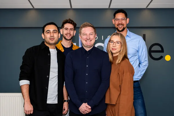 Five members of the Double Glazing Leads team together in the office