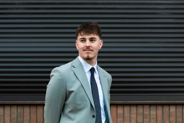 A Double Glazing Leads team member in a light suit outside the office